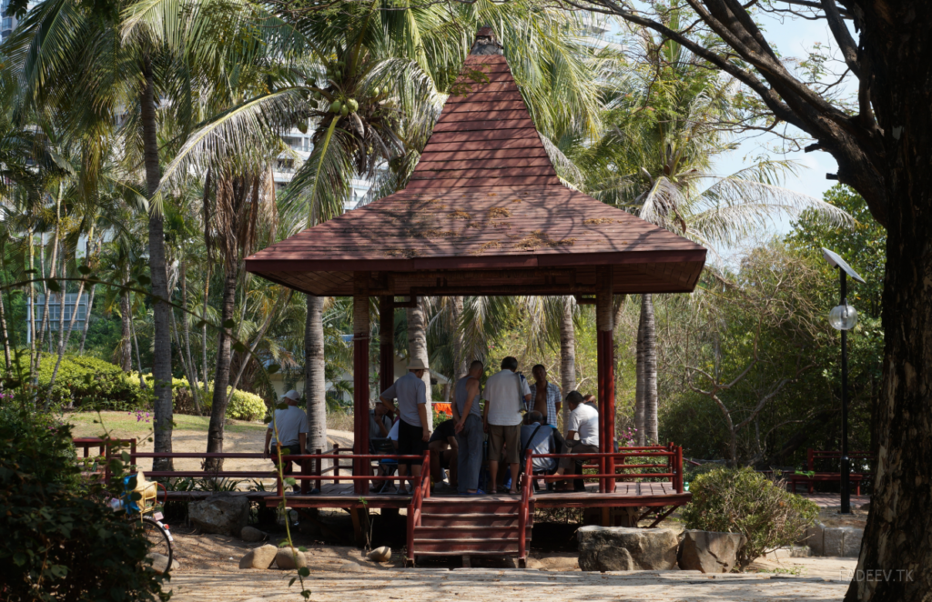 Residents have a rest in a park in Sanya, Hainan Island, China