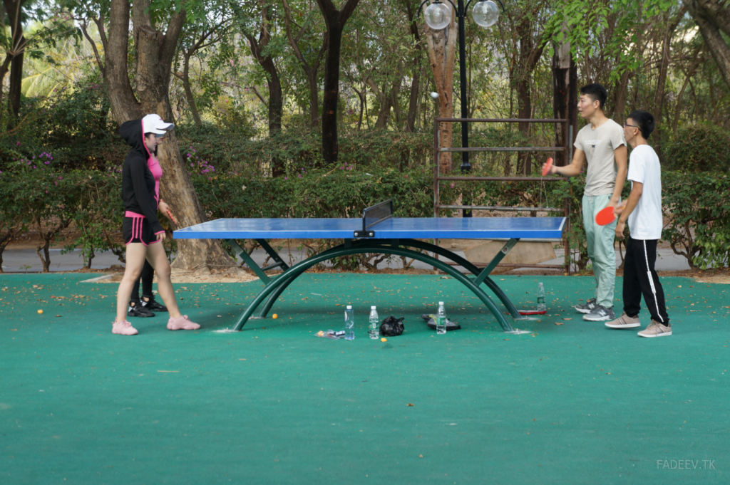 Young people play ping-pong in a park in Sanya, Hainan Island, China